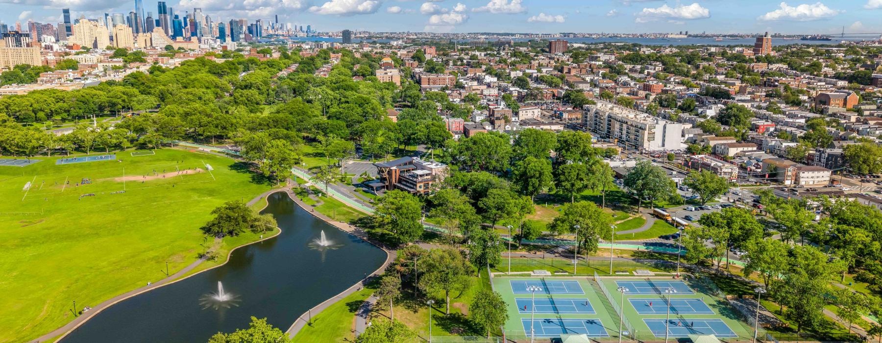a large pool with a city in the background